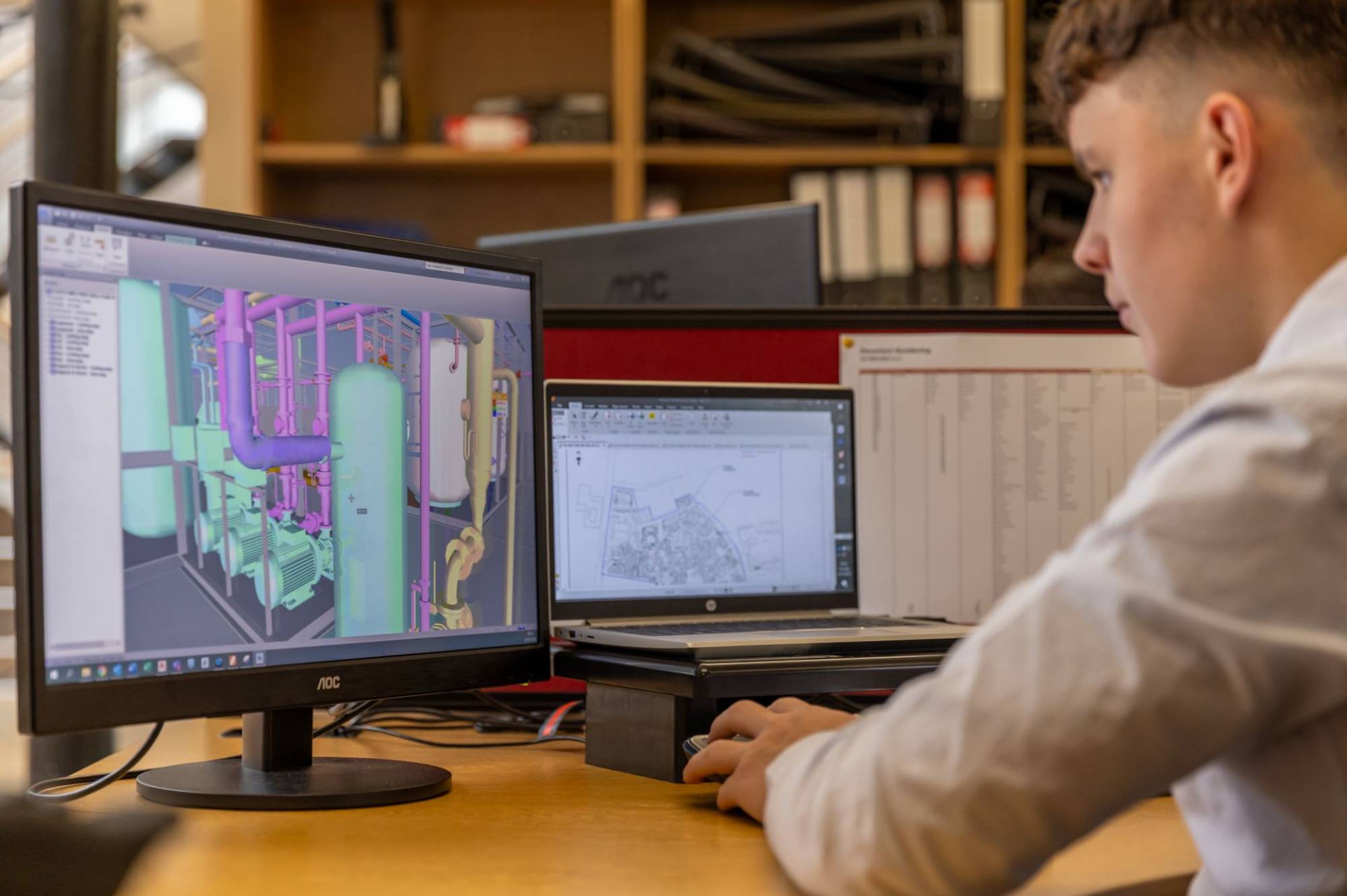 Person working on engineering drawing